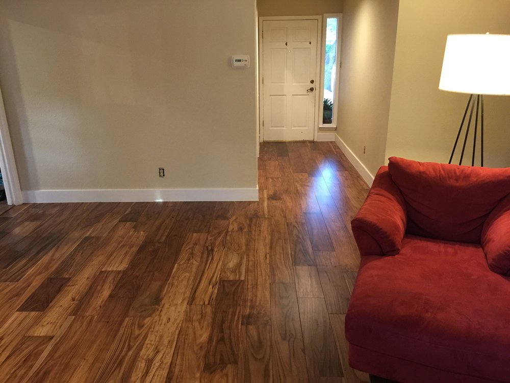 living room with hardwood floor Peoples Signature Flooring Austin Texas, 7.5 Inch Wide Hand Sculpted Acacia Natural 1x8 Baseboards