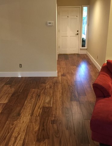 living room with hardwood floor Peoples Signature Flooring Austin Texas, 7.5 Inch Wide Hand Sculpted Acacia Natural 1x8 Baseboards