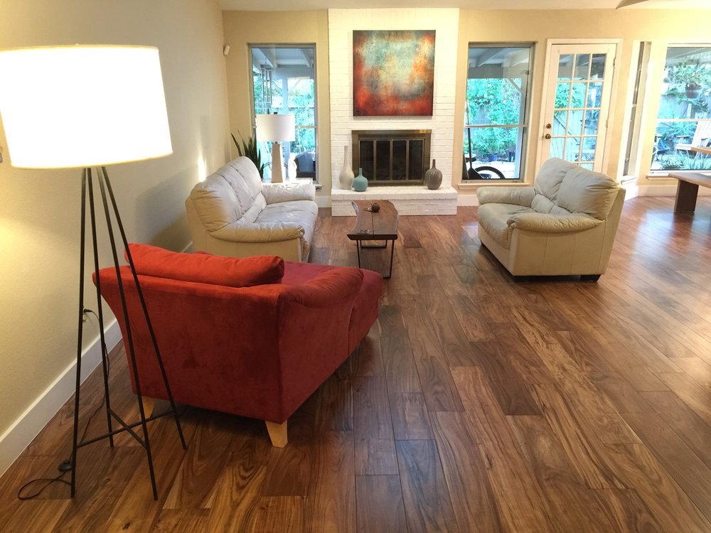 living room with hardwood floor Peoples Signature Flooring Austin Texas, 7.5 Inch Wide Hand Sculpted Acacia Natural 1x8 Baseboards