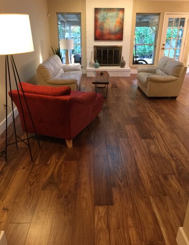 living room with hardwood floor Peoples Signature Flooring Austin Texas, 7.5 Inch Wide Hand Sculpted Acacia Natural 1x8 Baseboards