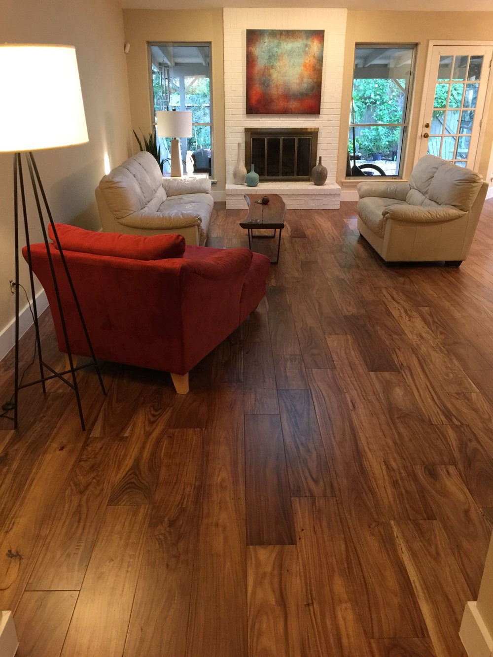 living room with hardwood floor Peoples Signature Flooring Austin Texas, 7.5 Inch Wide Hand Sculpted Acacia Natural 1x8 Baseboards