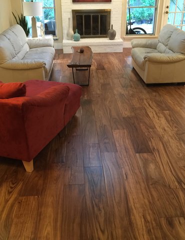 living room with hardwood floor Peoples Signature Flooring Austin Texas, 7.5 Inch Wide Hand Sculpted Acacia Natural 1x8 Baseboards